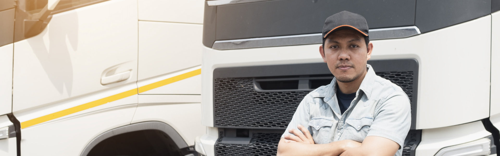 Portrait of truck driver standing cross one’s arm looking with smile